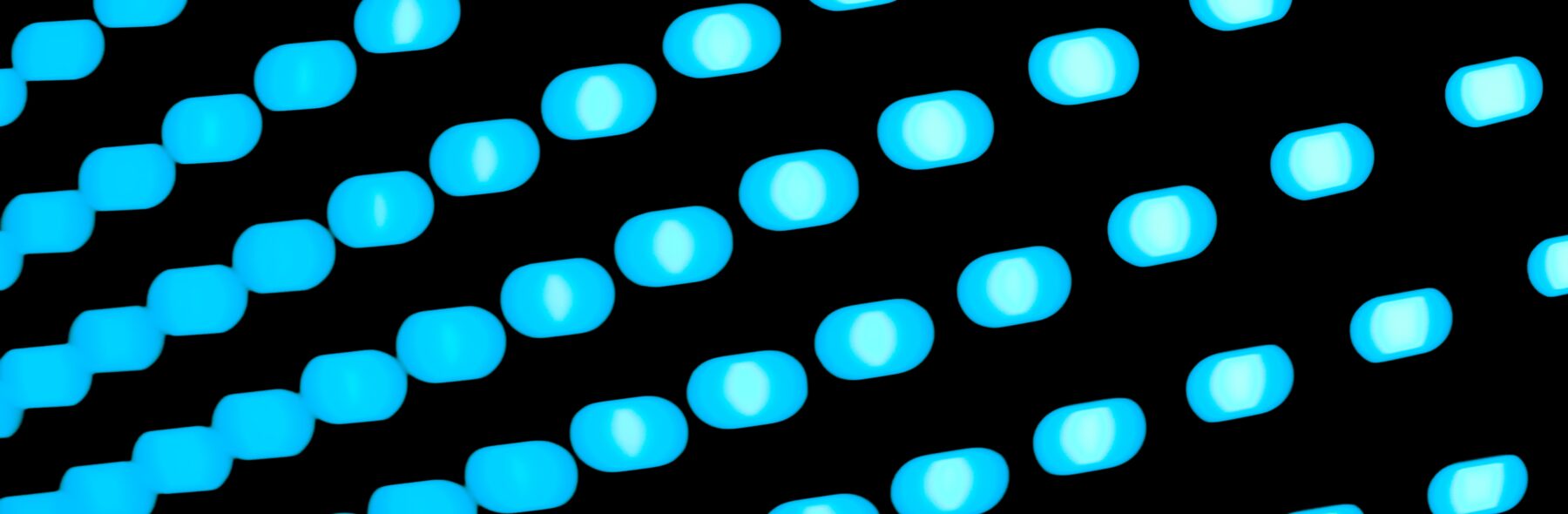 Blue lights on black background going diagonally across image.