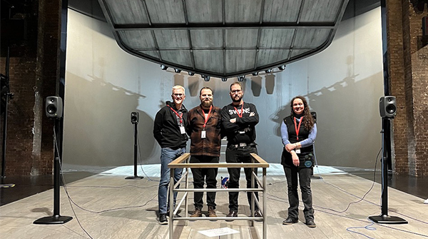 The XR Network+ project team on stage at the Royal Shakespeare Theatre, with working lights in between shows.